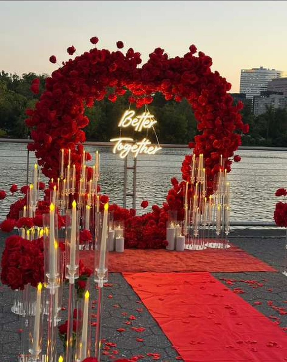 Romantic red rose proposal arch by the water